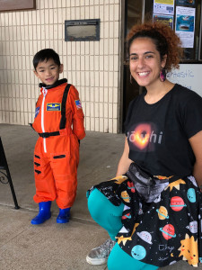 An aspiring astronaut visits with Miriam “Aunty Mimi” Fuchs, telescope system specialist at the East Asian Observatory, after Aunty Mimi’s Spectacular Science Show.